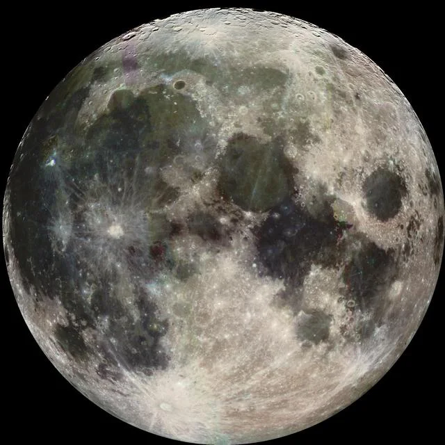 Galileo photograph of the Moon, with dark plains and bright crater rays inside its full disk.